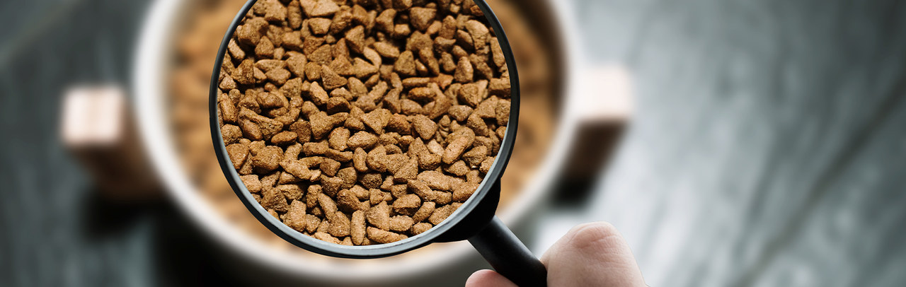 cat and dog food seen through a magnifying glass